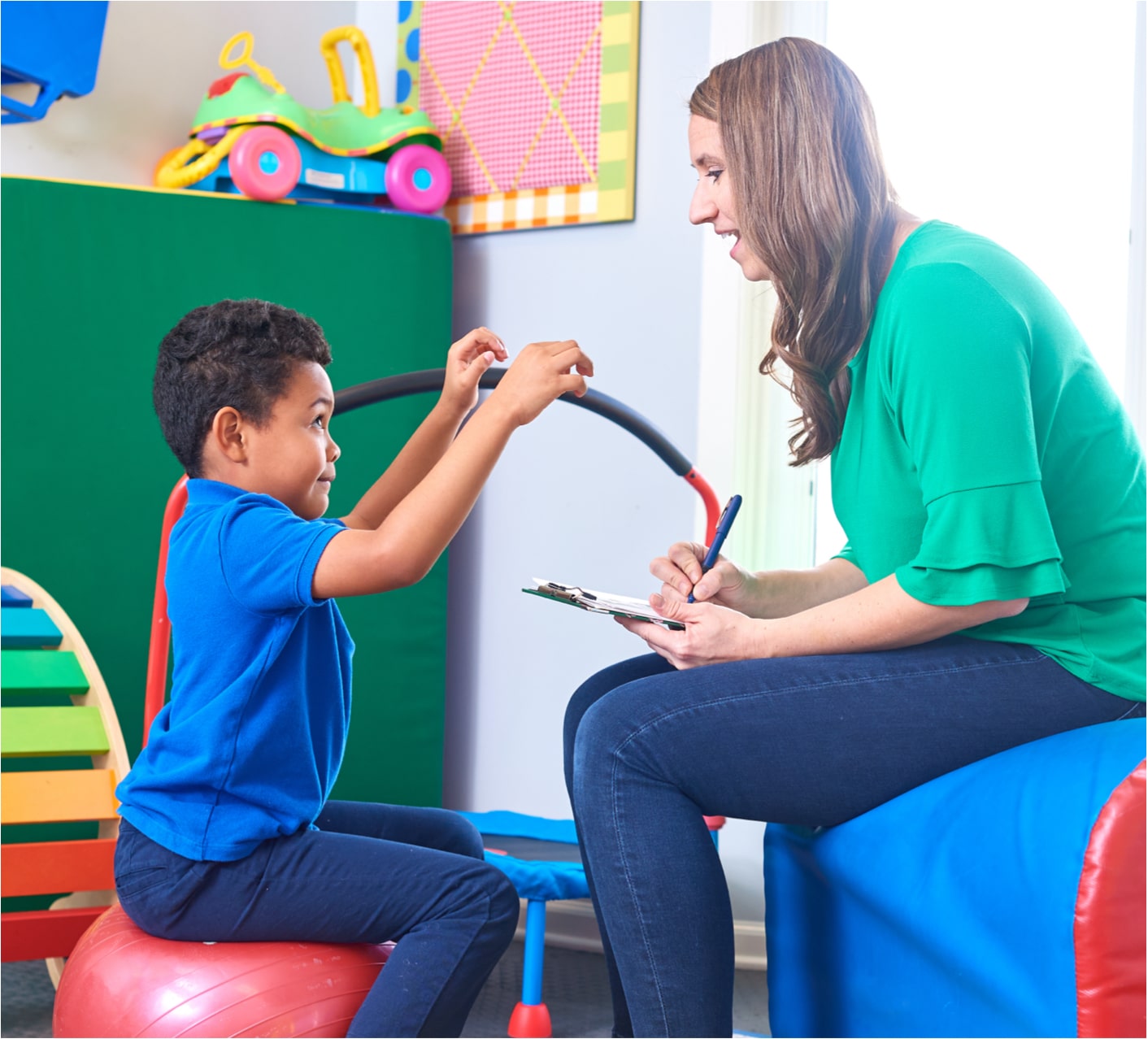 Therapist working with a child in play room